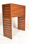 A 1960's retro vintage staples ladderax teak wood bureau / desk cabinet raised on shortened room