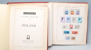 Two Schaubek Poland partially full stamp albums with pages 1 - 145 with some spare pages throughout.