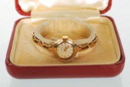 A 9ct gold 3 / 375 marked ladies gold dress watch with 9ct gold marked expanding bracelet strap. The