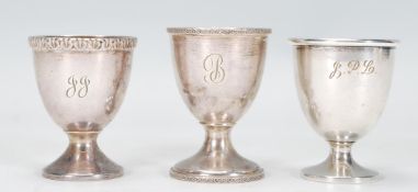 A collection of three Edwardian hallmarked Silver Egg Cups to include: One egg cup by H.H of