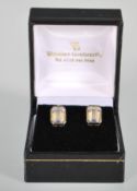 A pair of silver stud earrings having faceted square cut CZ's. Stamped 925 to verso. Gross weight