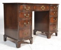 A reproduction 20th Century Georgian revival kneehole bow fronted twin pedestal writing desk with
