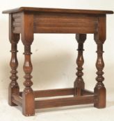 A 1920's shipping oak Jacobean revival peg joint stool in oak being raised on turned legs united