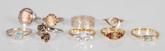 A collection of silver and gold plated rings to include two stamped silver cameo ring, a pierced