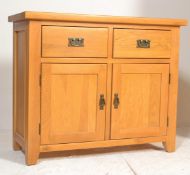 A good quality contemporary oak sideboard being raised on block legs with twin door cupboard under
