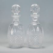 A pair of Waterford crystal cut glass decanters in the Colleen pattern, having faceted bulbous