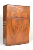 An Art Deco walnut bow fronted cocktail cabinet, the top opening to reveal a glass back fitted