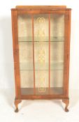 An early 20th Century Art Deco walnut display china cabinet, glazed single door with flanked by