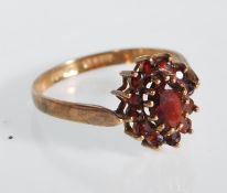 An English hallmarked 9ct yellow gold ladies dress ring having a central claw set oval faceted cut