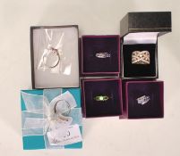 A collection of six ladies silver dress rings to include a ring set with a round cut green stone