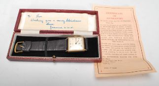Audax - A vintage hallmarked 9ct gold wrist watch on a leather strap. The square silvered face