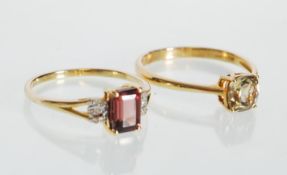Two hallmarked  9ct gold ladies dress rings. One ring being set with a red gemstone flanked with