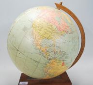 A retro 20th Century desk top Philips 12 Inch Terrestrial globe with 12 gores, raised on a wooden