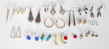 A large quantity  of silver earrings to include a pair of hallmarked vermeil hoop earrings, a pair