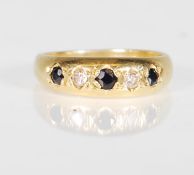A hallmarked 18ct gold ladies ring set with three round cut sapphires and two round cut diamonds.