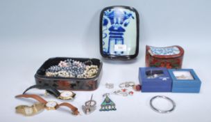 A collection of vintage costume jewellery to include a gilt silver brooch set with round cut red