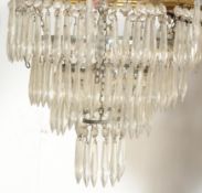 A mid century large 3 section drop Empire chandelier having multiple facet cut glass droplets set to