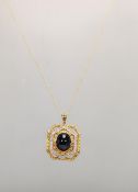 A 9ct gold hallmarked Indian pendant necklace, the pendant set with central cabochon stone