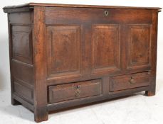 A 17th century carved oak large mule chest coffer being raised on stile supports having two short