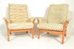 A pair of large Ercol Renaissance light elm armchairs complete with upholstered cushions in very