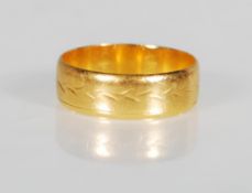 A 22ct gold gentleman's wedding band ring having engraved decoration. Hallmarked Birmingham 1972.