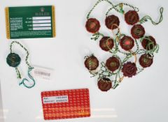 A collection of twelve Rolex Officially Certified Chronograph plastic watch labels together with a