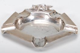 A silver hallmarked and engine turned cigar ashtray with applied sculptural silver fox to the