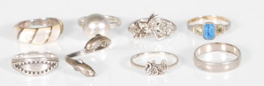 A group of silver rings to include a fairy ring, an elephant ring, a twist design hring set with