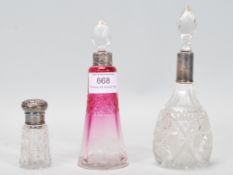 A group of three 19th Century Victorian dressing table perfume bottles, to include a pink glass