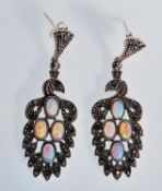 A decorative pair of silver and marcasite drop earrings each set with four central opal cabochon.