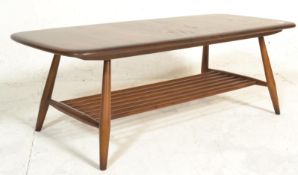 A 1970's retro vintage Ercol Windsor elm wood coffee table having a spindle magazine rack