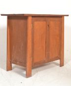 An antique style Arts & Crafts cabinet sideboard. Of shaped form with angled body set with double