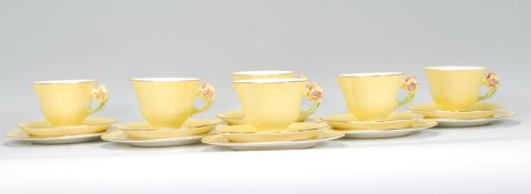 A vintage 20th Century Royal Winton hand painted tea service in the Petunia pattern having yellow