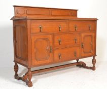 An early 20th Century block fronted oak sideboard credenza having a configuration of cupboards and