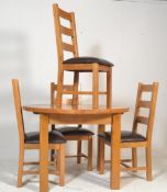 A good quality contemporary oak circular extending dining table and chairs suite. Raised on block