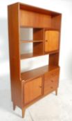 A retro mid 20th Century teak wood room unit having fitted shelves above a configuration of three