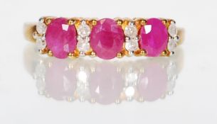 A 9ct gold ladies sapphire and diamond dress ring set with three sapphire gemstones flanked by eight