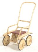A vintage 20th Century child's doll / bear push along chair of metal tubular construction finished