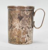 A 20th Century 800 silver Christening mug of small proportions having a hammered finish and lip to