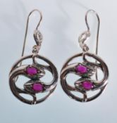 A pair of round snake like drop earrings having the centres moulded in to snake heads set with