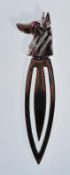 A silver bookmark in the form of a dogs head set with a red stone eye. Weighs 3.6g. Measures 6cm