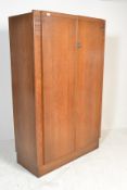 An early 20th Century Ernst Gomme for G Plan oak double wardrobe, two panel doors opening to