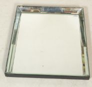 A 20th Century wall mirror of rectangular form having bevelled glass with an angular form mirror