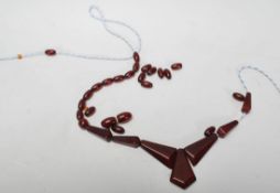 A vintage 20th Century cherry amber bakelite necklace. The necklace in the process of being restrung