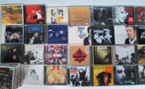 A collection of music compact discs featuring various artists to include The White Stripes, Miles