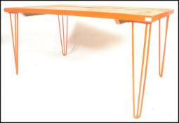 A modernist contemporary metal framed refectory dining table raised on hairpin upright supports in