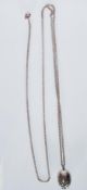 An English hallmarked silver fashion necklace having an egg shaped pendant with pierced decoration