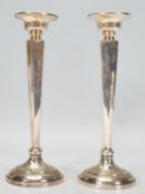 A pair of 1920's Art Deco Saunders & Shepherd silver hallmarked candlesticks raised on round bases