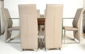 A contemporary large designer modernist glass dining table. Raised on glass panel uprights with