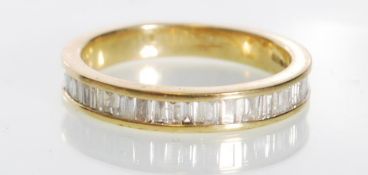 A hallmarked 9ct gold and diamond half eternity ring set with baguette cut diamonds. Diamonds approx